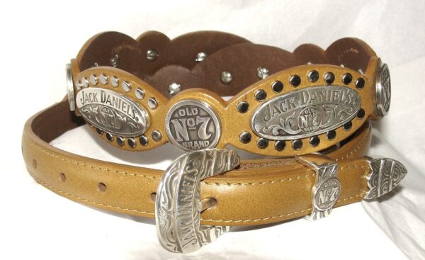 A tan leather belt with a silver buckle.