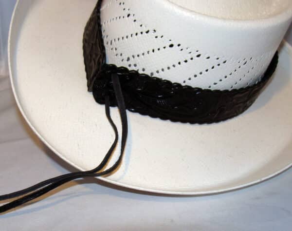 A white cowboy hat with a 1.5" Tooled leather Black Cowboy Hat Band.