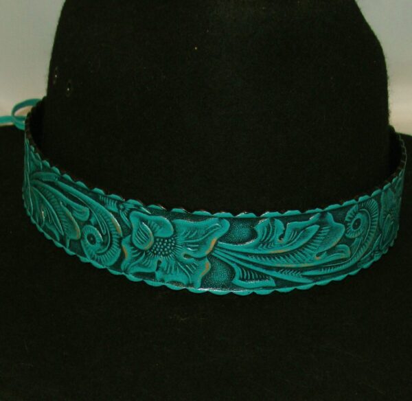 A 1.5" Tooled leather Turquoise Teal Cowboy Hat Band with a floral design on it.