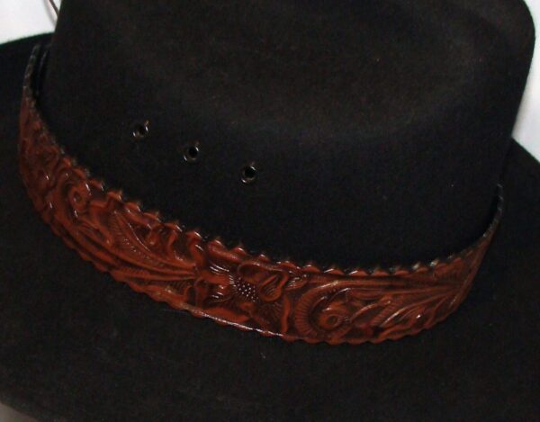 A black hat with a 1.5" Tooled leather Brown Cowboy Hat Band.
