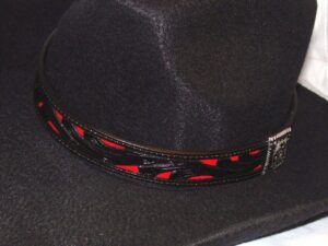 A black hat with a red and black engraved band