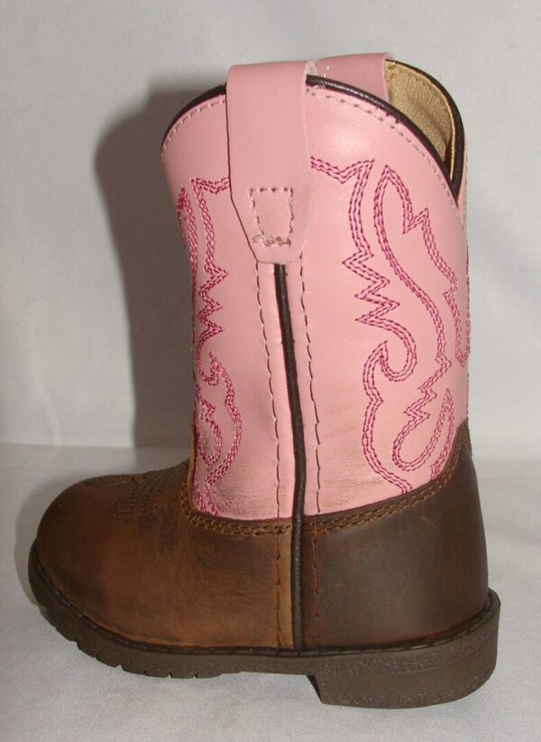 A "Pink Hopalong" leather toddler cowboy boot on a white surface.