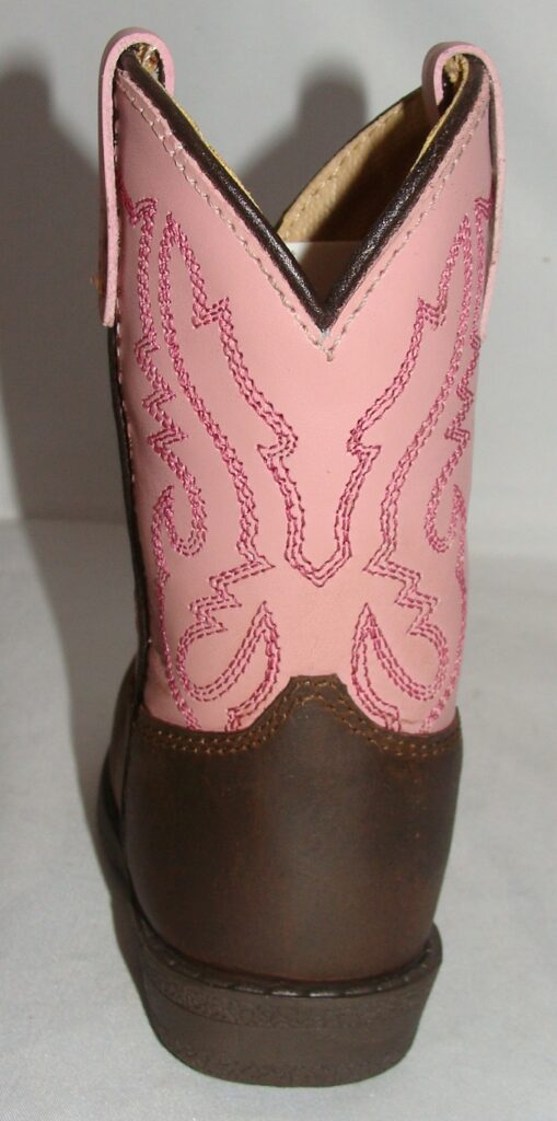 A "Pink Hopalong" leather toddler cowboy boot on a white surface.