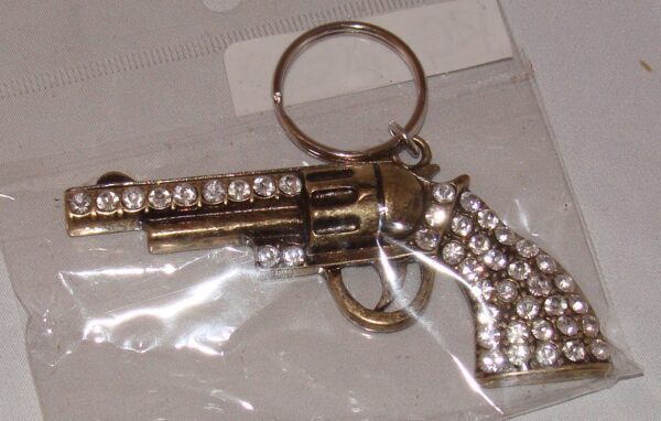 A Gold Rhinestone Gun Pistol Keychain, Western Keyring with rhinestones on it.