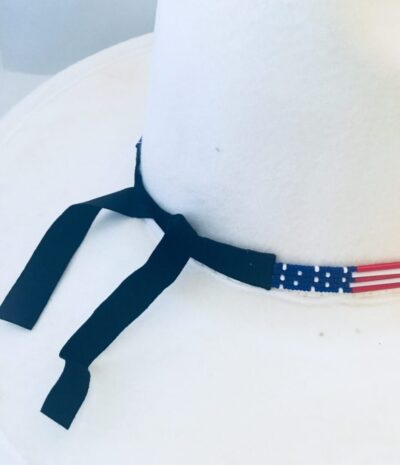 A hat with a Glass quill 5 strand "USA Flag" USA MADE hat band on it.