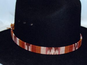 A black hat with a Tapestry Brown Southwestern Cowboy Hat Band.
