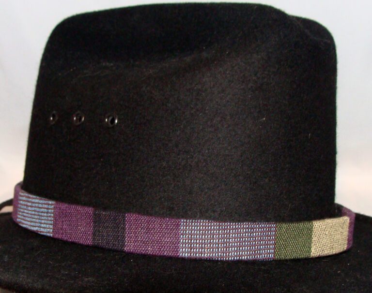 A black hat with a Tapestry Purple Southwestern Cowboy Hat Band.