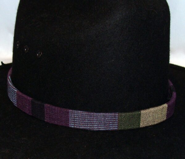 A black hat with a Tapestry Purple Southwestern Cowboy Hat Band.