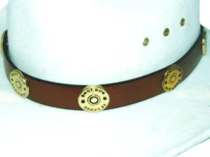 A brown leather cowboy hat with a Brass Shotgun Shell Brown Leather Cowboy Hat Band on its band.