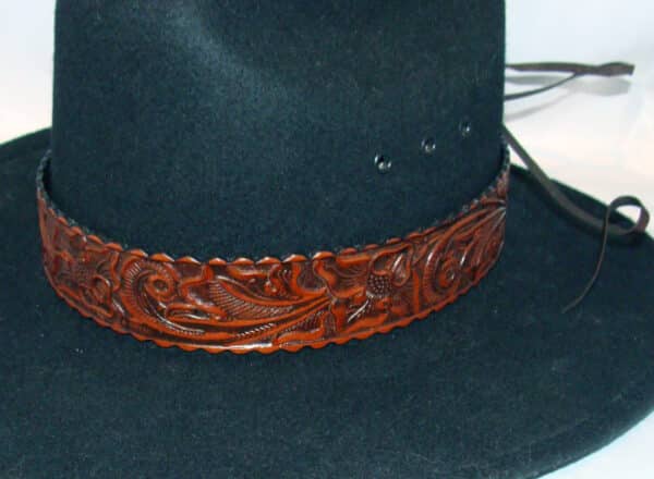 A black cowboy hat with a 1.5" Tooled leather Brown Cowboy Hat Band.