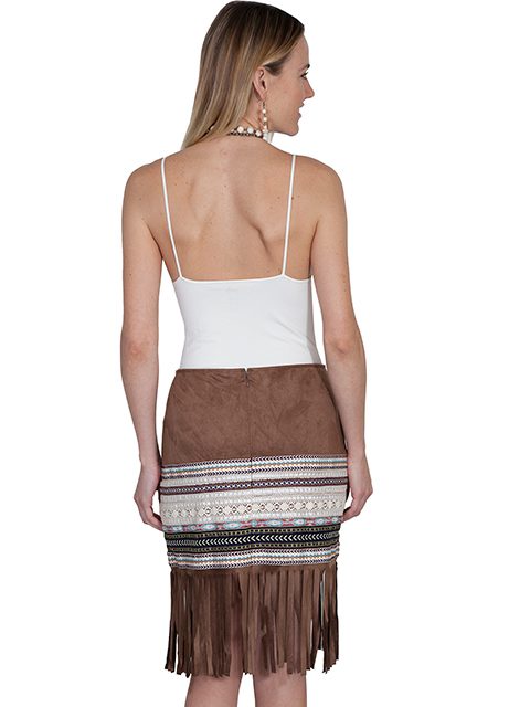 The back view of a woman wearing a Scully Womens 70's Style Tan Fringe Western Skirt.