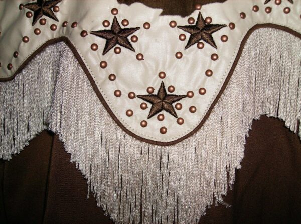 A close up of a Scully 'Lady Bonanza' brown western star women's fringe shirt with fringes and stars.