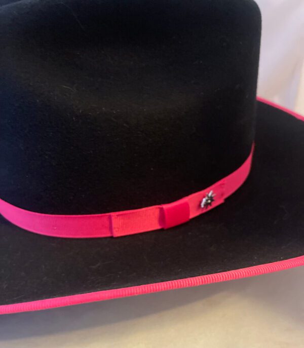 An USA made 'Brittany' Kids Bailey Hot Pink Trim Wool Cowgirl Hat with a pink ribbon on it.