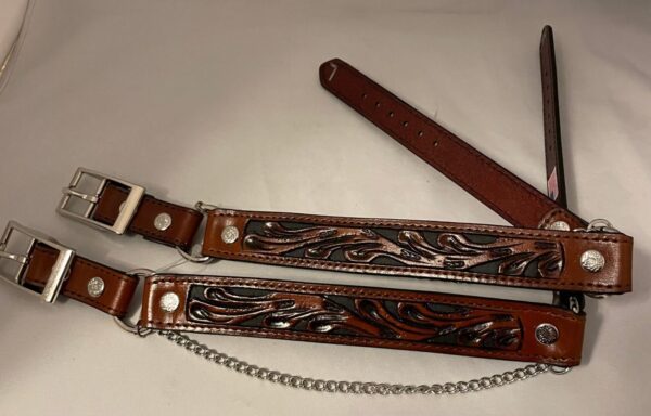 A pair of Brown & Black Inlay Leather Cowboy boot chains - USA with a chain attached to them.