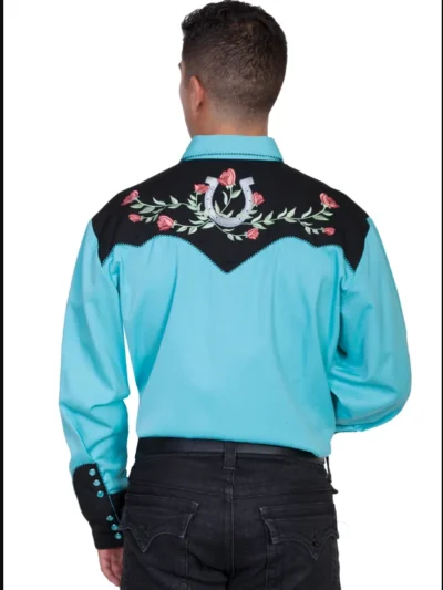 A man wearing the "Winners Circle" Mens Turquoise Western shirt by Scully with intricate embroidery.