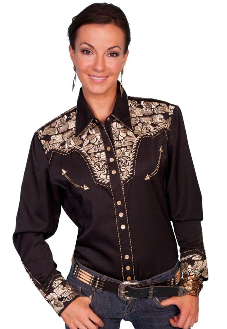 A woman wearing a black and gold western shirt.