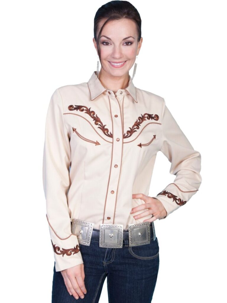 A woman wearing a Scully womens Large tan embroidered western shirt and jeans.