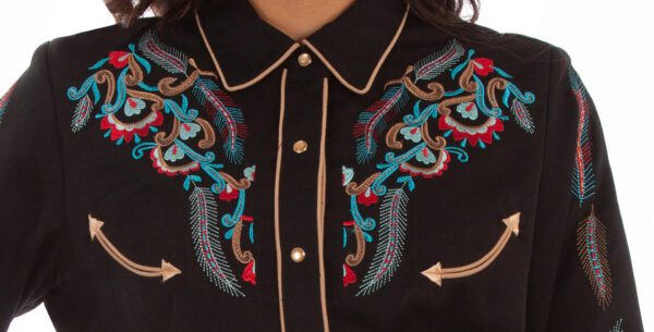 A woman wearing a Scully Women's Embroidered Feathers Black Denim Western Shirt.