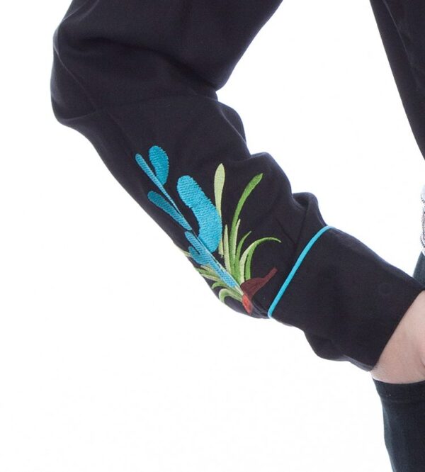 A woman wearing a Womens Scully Turquoise Cactus Retro Black Western Shirt with embroidered flowers.