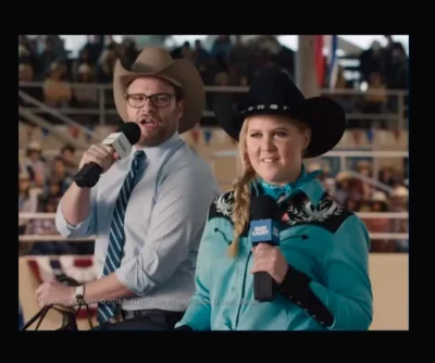 A man and woman in cowboy hats are holding microphones while wearing the "Winners Circle" Mens Turquoise Western shirt by Scully.