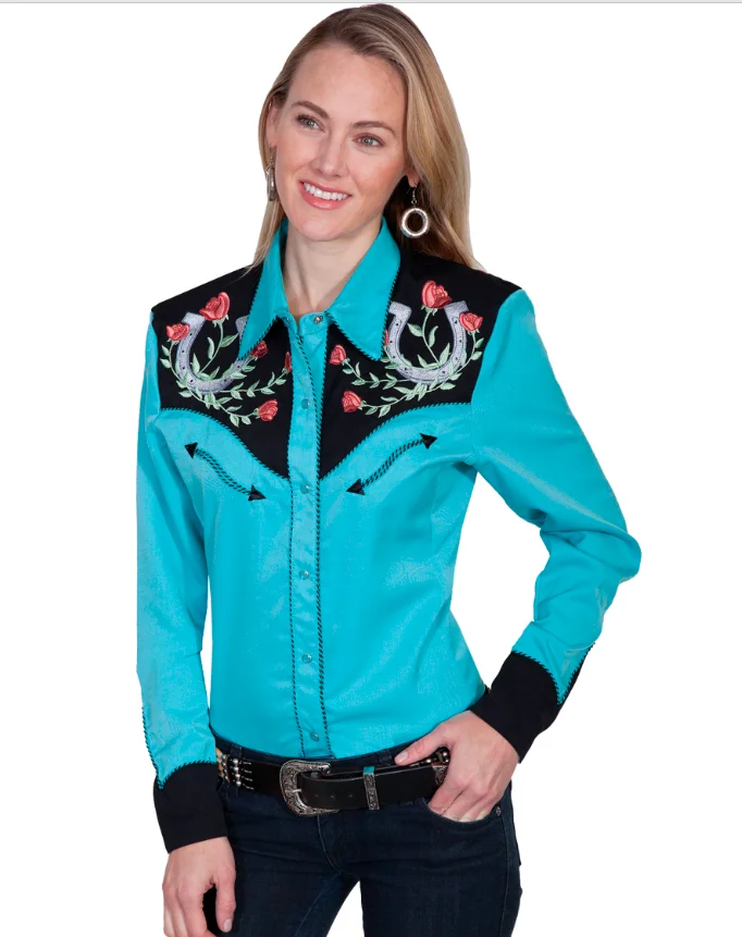 A woman wearing the "Winners Circle" Mens Turquoise Western shirt by Scully.