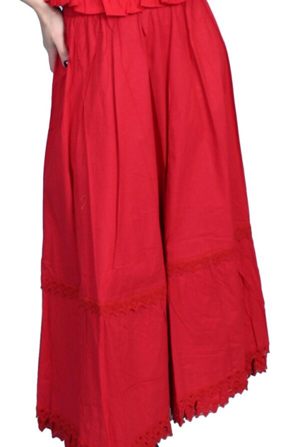 A woman is wearing a red skirt with ruffles.