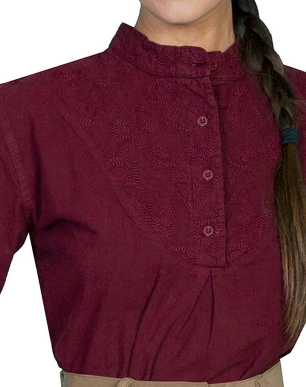 A woman wearing a Scully Womens Paisley Round Bib front Burgundy blouse with braided hair.
