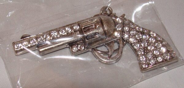 A Gold Rhinestone Gun Pistol Keychain, Western Keyring in a package with diamonds on it.