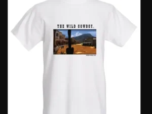 The Wild Cowboy" Mens White short sleeve western Town T-shirt with a picture of a city.