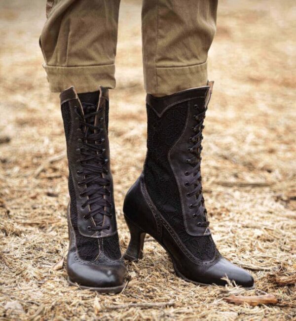 A woman's legs are standing on dirt in a pair of Abigale Black Rustic Leather & Lace Women's Granny Boots.