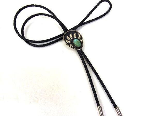 A black and Turquoise Stone Silver Raised Bear Claw Bolo Tie with a paw print on it.