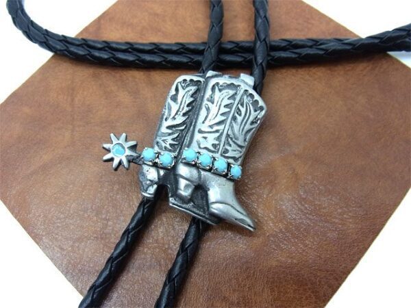 A Silver Double Cowboy Boots Turquoise Bolo Tie necklace with turquoise and black leather.