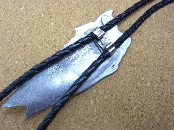 A silver and black Vintage Western Horse Head Bolo Tie with a leather cord.