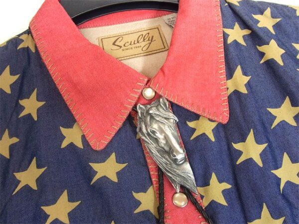 A shirt with stars and a Vintage Western Horse Head Bolo Tie on it.