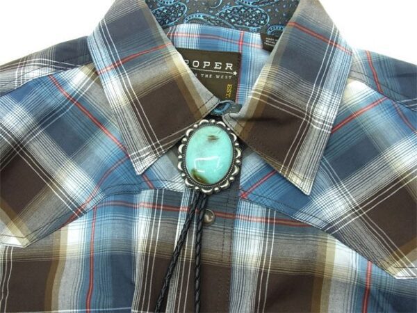 A Large Oval Turquoise Western Bolo Tie with a tassel.