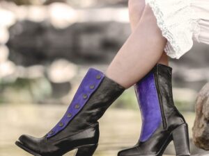A woman wearing Amelia Poison Leather Button Snap Womens Purple Zip Granny Boots.