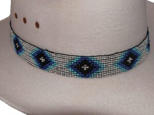 A hat with a Blue and Black beaded Navajo design white stretch hat band.