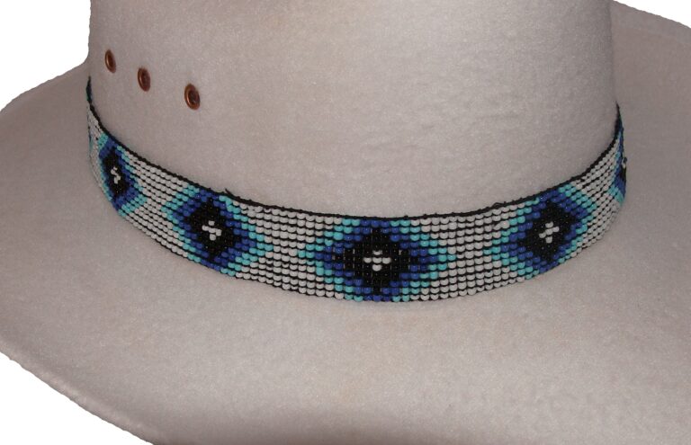 A hat with a Blue and Black beaded Navajo design white stretch hat band.