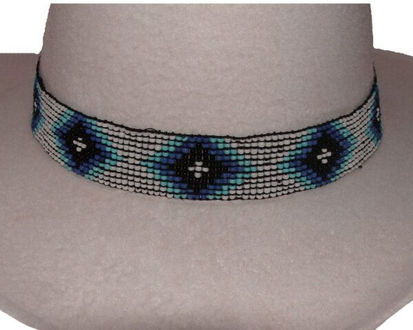 A blue and black beaded Navajo design white stretch hat band on a mannequin.