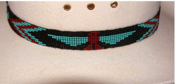 A Turquoise Hand Beaded Firebird Cowboy Hat Stretch Band with an eagle on it.