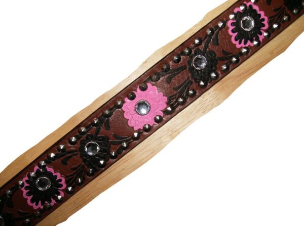 A Brown tooled floral leather rhinestone western belt with pink and brown flowers on it.