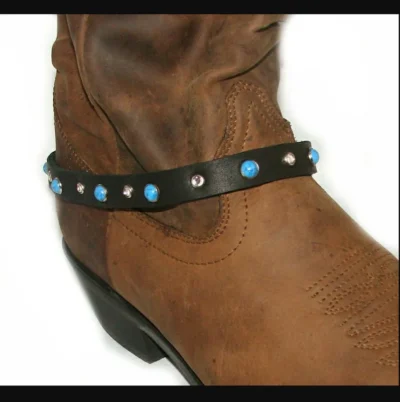 <div class="qsc-html-content"> Black Leather Cowboy boot bracelet <ul style="list-style: square inside none;"> <li>rhinestone and turquoise studded</li> <li>Sold as 1 each</li> <li>adjustable chain</li> <li>USA MADE</li> </ul> </div> •