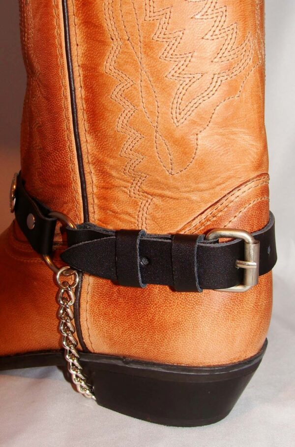A tan cowboy boot with the USA American Flag Leather Cowboy Boot Chains on it.