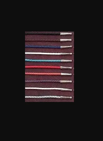 A row of USA MADE Leatherette Bolo Tie Strings, Cords - Pick Colors on a black background.