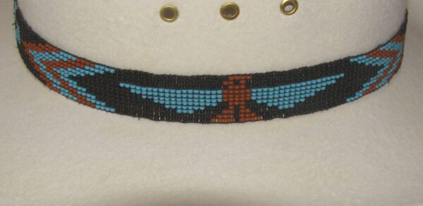 A Turquoise Firebird Hand Beaded Horse Hair Tassel Hat Band with an eagle on it.