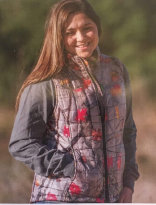 A woman in a Women's HotLeaf Camo Western Trail Vest posing for a photo.