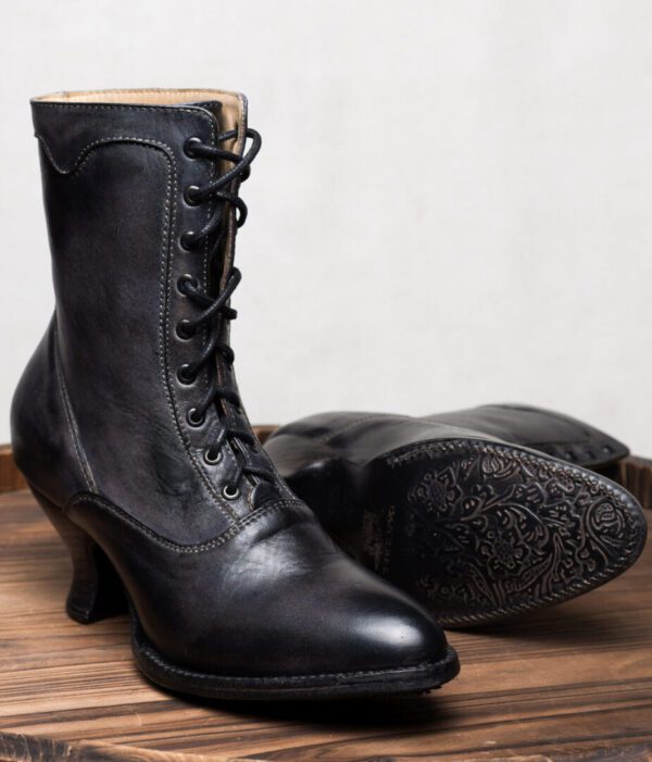 A pair of Eleanor Black Leather Womens Granny Boots on a wooden table.