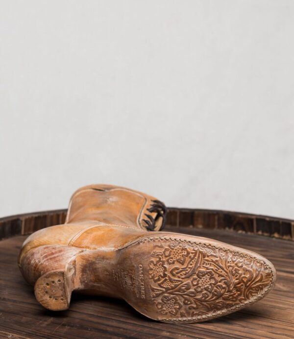 A pair of Eleanor Tan White Leather Womens Granny Boots on a wooden table.