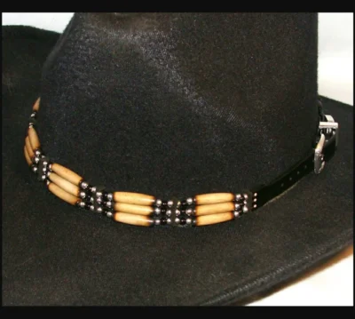 Silver beaded Black Onxy Cow Bone hat band <ul style="list-style: square inside none;"> <li>Real cow bones</li> <li>Silver plated beads</li> <li>Sliver buckle</li> <li>Fits up to 25"</li> <li>Size: 1/2" wide</li> <li>MADE IN THE U.S.A</li> </ul> •