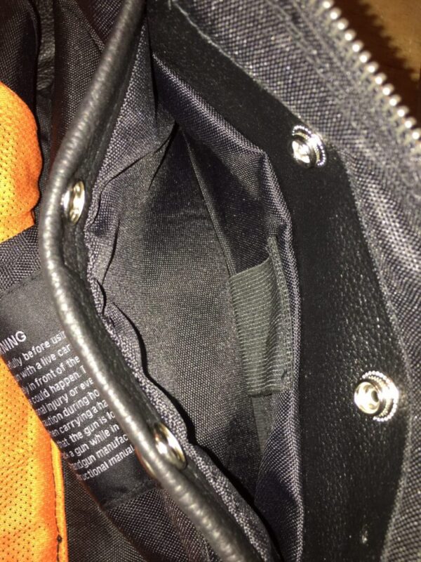 A close up of a Womens Brown Reflective Piped Black Gun Pocket Vest.